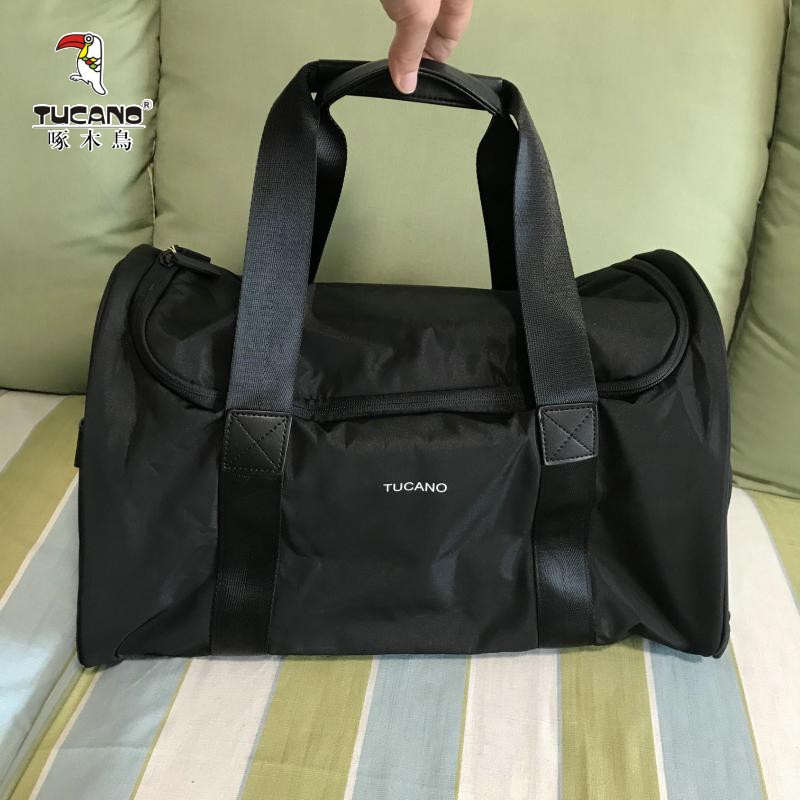 啄木鸟旅行包手提袋男女通用出差包2021新款黑色百搭旅行袋包包
